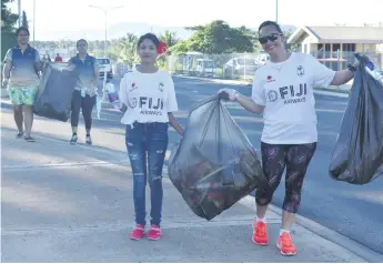  ?? Photo: Waisea Nasokia ?? Fiji Airways staff members Zureen Bibi and Velda Young during the clean-up campaign in Namaka on May 5, 2018.