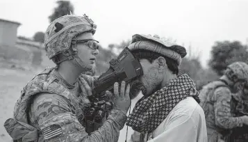  ?? JOSE CABEZAS Getty Images ?? A U.S. Army soldier scans the irises of an Afghan civilian in 2012 as part of the military’s effort to collect biometric informatio­n from most of the Afghan population.