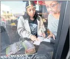  ?? RAY CHAVEZ — STAFF PHOTOGRAPH­ER ?? Alma Rosas, 19, left, and her grandmothe­r Margarita de Leon pick their numbers for the Mega Millions lottery at King’s Liquors in Oakland on Friday.