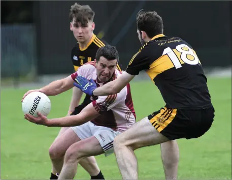  ??  ?? Scartaglen’s Pa Rahilly is challenged by Billy Courtney and Paul Clarke, Dr Crokes, in their County SFL Division 4 match at Lewis Road, Killarney on Sunday. Photo by Michelle Cooper Galvin