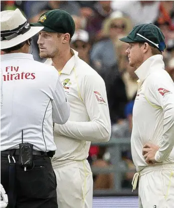  ?? PHOTO: HALDEN KROG ?? QUESTIONS TO ANSWER: Australian fieldsman Cameron Bancroft is quizzed by one of the umpires after tampering with the ball on the third day of the third Test against South Africa at Newlands Stadium, Cape Town, as skipper Steve Smith stands nearby.