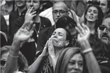  ?? Associated Press ?? A protester reacts Friday as she takes part in a rally outside the Catalan Parliament in Barcelona, Spain.