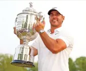  ?? ?? Brooks Koepka celebrates with the Wanamaker Trophy after winning the PGA Championsh­ip on Sunday (AFP)