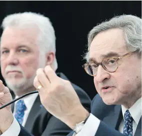  ?? GRAHAM HUGHES/ THE CANADIAN PRESS ?? Caisse CEO Michael Sabia, right, and Quebec Premier Philippe Couillard announce details of a new light rail system for the Montreal area Thursday, which was awarded to SNC-Lavalin and France’s Alstom. Couillard reassured Bombardier there will be other...