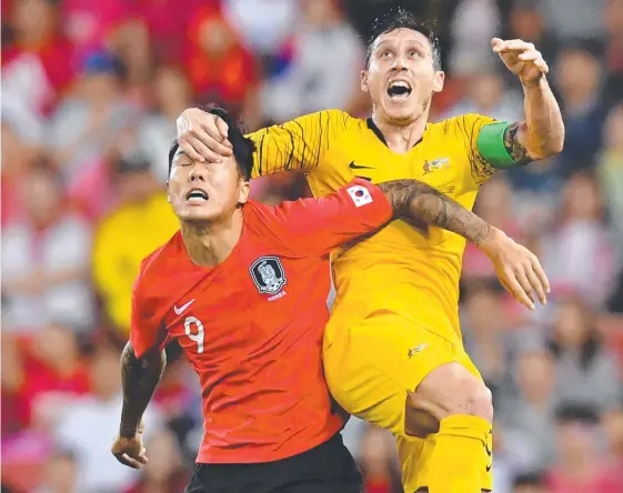  ?? Picture: AAP/DARREN ENGLAND ?? Socceroo Mark Milligan battles South Korea’s Suk Hyunjun in Saturday night’s internatio­nal friendly at Suncorp Stadium.