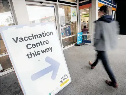  ?? Photos / Jason Oxenham, AP ?? New Zealand insurers say Covid-19 treatment is largely through the public system here, unlike in the US (left) where big costs are being met by private insurers.