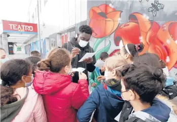  ?? ANTONIO CALANNI/AP ?? Giuseppe Dave Seke, lead actor in the Netflix series “Zero,” signs autographs on April 27 in Milan.