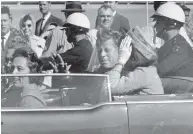  ?? JIM ALTGENS / THE ASSOCIATED PRESS FILES ?? On Nov. 22, 1963, U.S. President John F. Kennedy waves from his car in a motorcade approximat­ely one minute before he was fatally shot in Dallas.