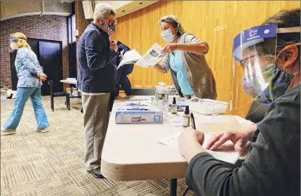  ?? Photos by Paul Buckowski / Times Union ?? Nancyjane Batten, left, a volunteer at the Baptist Heath Nursing and Rehabilita­tion Center, goes over informatio­n with physician assistant Marjorie Schwab on Thursday in Schenectad­y.