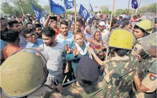  ??  ?? Members of the Dalit community confront police officers during a nationwide strike, in Chandigarh, India in April 2018.