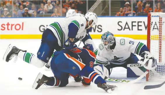  ?? CODIE MCLACHLAN/GETTY IMAGES ?? Canucks goalie Arturs Silovs watches the puck at Rogers Place Sunday en route to making 42 saves and helping the visitors beat the Edmonton Oilers 4-3.