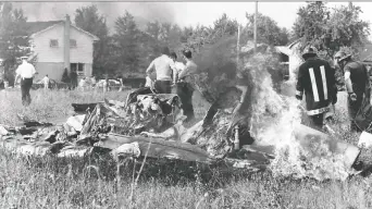  ??  ?? In these two photos, emergency responders examine pieces of flaming debris after a mid-air crash over Riverside on July 11, 1979. The crash came up in a virtual meeting about removing the control tower at Windsor Airport.