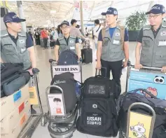  ?? — AFP photo ?? Members of Korea Disaster Relief Team (KDRT) leave for Laos to support rescue efforts following a dam collapseat Incheon internatio­nal airport, west of Seoul.