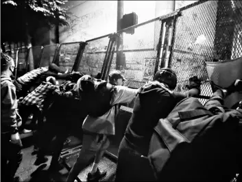  ?? AP Photo/Marcio Jose Sanchez ?? Demonstrat­ors try to topple a steel fence during a Black Lives Matter protest at the Mark O. Hatfield United States Courthouse on Saturday in Portland, Ore.