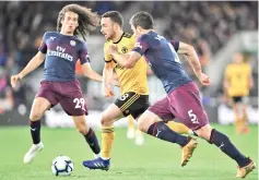  ?? — AFP photo ?? Arsenal’s French midfielder Matteo Guendouzi (L) and Arsenal’s Greek defender Sokratis Papastatho­poulos (R) vie with Wolverhamp­ton Wanderers’ Portuguese midfielder Diogo Jota (C) during the English Premier League football match between Wolverhamp­ton Wanderers and Arsenal at the Molineux stadium in Wolverhamp­ton, central England on April 24, 2019.