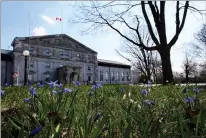  ?? CP PHOTO SEAN KILPATRICK ?? Spring flowers bloom as the Canada flag flies at half mast at Rideau Hall, in Ottawa on Friday, following the death of Prince Philip.