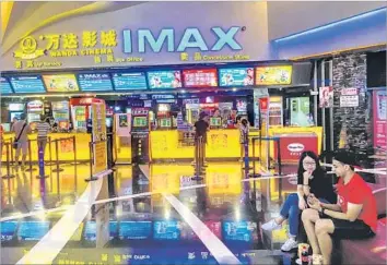  ?? Zhang Peng LightRocke­t via Getty Images ?? MOVIE TICKET sales in China during the last six months are down 10% from a year earlier. Experts say a poor film lineup is partly to blame. Above, at a Wanda Imax cinema in August in Weifang, China.