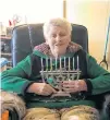  ?? CONTRIBUTE­D ?? Cameille Sherman holds her menorah. She has celebrated both Hannukah and Christmas over the years with her Jewish husband, Marvin Sherman, who has since passed away.