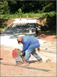  ?? NWA Democrat-Gazette/FLIP PUTTHOFF ?? Roberto Estevane cuts re-bar Thursday near the Horsebarn Trailhead in Rogers on the Trail of Two Cities, a pedestrian and bike path between Rogers and Bentonvill­e. The trail meanders west from the Horsebarn Trailhead in Rogers to Southwest I Street in...