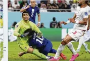  ?? ASSOCIATED PRESS ?? Christian Pulisic collides with Iran’s goalkeeper Alireza Beiranvand after scoring the only goal in the U.S. team’s win Tuesday in Doha, Qatar.