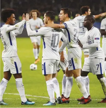  ??  ?? Cesar Azpilicuet­a and N’Golo Kante join Chelsea’s goalscorer Hazard and Willian to celebrate the Blues’ opening goal in Baku, yesterday. Chelsea won 4-0