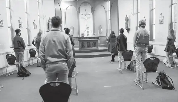  ?? Owen Bonaventur­a photo ?? Faith can play a tremendous role in the lives of many people. Above, students from St. Joseph High School in Trumbull participat­e in a Catholic mass at the school during the pandemic.