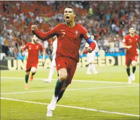  ?? Francisco Seco / Associated Press ?? Portugal’s Cristiano Ronaldo celebrates his side’s opening goal during the group B match between Portugal and Spain on Friday in Sochi, Russia.