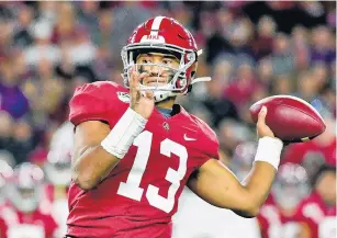  ?? VASHA HUNT/ASSOCIATED PRESS FILE ?? Tua Tagovailoa, above, joins Joe Burrow and Justin Herbert as the consensus top three quarterbac­ks in this week’s NFL draft.