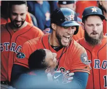  ?? GREGORY SHAMUS GETTY IMAGES ?? George Springer of the Houston Astros celebrates with Tony Kemp after hitting a homer against the Indians in Cleveland on Monday.