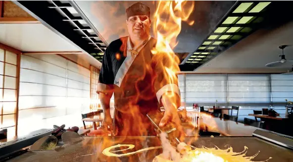  ??  ?? William Gould behind the hot plate at Nelson’s Miyazu restaurant.