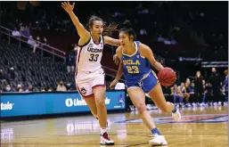  ?? Tribune News Service/getty Images ?? Natalie Chou (23) of the UCLA Bruins is in action against the Connecticu­t Huskies during a game in December 2021 at Prudential Center in Newark, New Jersey.