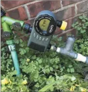  ?? LEE REICH VIA AP ?? This photo shows the beginning portion of a drip irrigation system at a home in New Paltz, N.Y. Watering with drip irrigation has many benefits, not the least of which is that it is easily automated by merely setting a timer. The timer is pictured here...