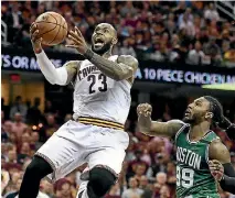  ?? PHOTOS: USA TODAY SPORTS ?? Kyrie Irving defends during the Cavaliers’ win over the Boston Celtics as LeBron James, right, prepares for a layup.