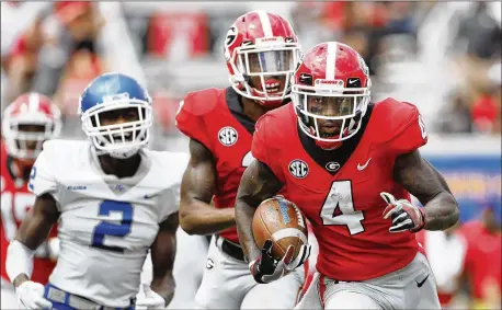  ?? BOB ANDRES / BANDRES@AJC.COM ?? Georgia wide receiver Mecole Hardman returns a first-half punt for a touchdown Saturday in Athens. The 70-yard sprint was the first career puntreturn touchdown — “my joy and dream” — for last season’s SEC leader in punt returns.