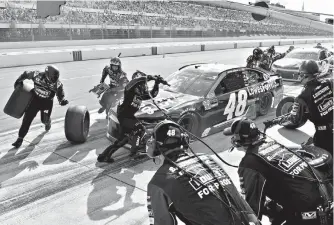  ?? AP Photo/Derik Hamilton ?? ■ Jimmie Johnson makes a pit stop during a NASCAR Cup Series race Sunday in Long Pond, Pa. Kyle Busch won the race.