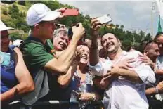  ?? AFP ?? Italy’s Interior Minister and Deputy Prime Minister Matteo Salvini takes a selfie with his supporters during the annual meeting of the far-right League party.