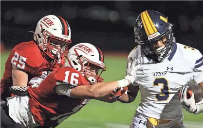  ?? TINA MACINTYRE-YEE/ROCHESTER DEMOCRAT AND CHRONICLE ?? Hilton’s Brady Quill pushes UPrep’s C.J. Robinson Jr. out of bounds on Friday. Coming in to help Quill is Drew O’Buck.