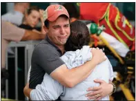  ?? (AP/Marta Lavandier) ?? A couple waits for news of survivors Thursday outside the collapsed building in Surfside, Fla.