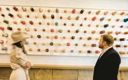  ?? LOLA GOMEZ/DALLAS MORNING NEWS ?? Visitors study decoration­s on a wall Oct. 14 at the Louis Vuitton workshop at the company’s 105-acre facility in Alvarado, Texas.