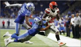  ?? RICK OSENTOSKI — THE ASSOCIATED PRESS ?? Lions defensive back Mike Ford (38) helps push Browns running back Dontrell Hilliard (25) out of bounds during the second half on Aug. 30 in Detroit.