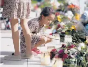  ?? DARIO LOPEZ-MILLS/AP ?? A child looks at a memorial Friday for the victims killed in this week’s shooting in Uvalde, Texas.