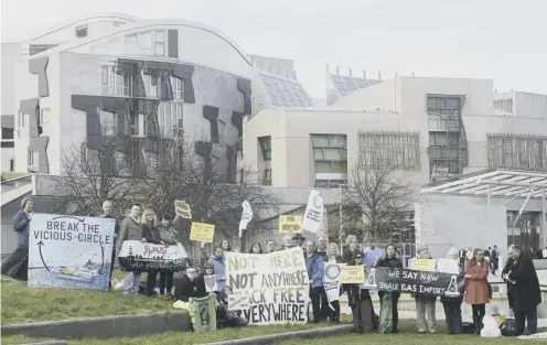  ?? PICTURE: GREG MACVEAN ?? 0 Protestors outside Holyrood as, inside the building, MSPS passed a much-strengthen­ed fracking ban