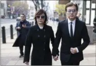  ?? AP PHOTO/MATT ROURKE ?? Sun Peng, right, and Di Ying walk from the federal courthouse in Philadelph­ia on Monday. Their son AnTso Sun, a Taiwanese exchange student accused of threatenin­g to “shoot up” his high school near Philadelph­ia has been spared additional time in prison but will be deported.