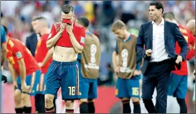  ?? AP/ANTONIO CALANNI ?? Spain’s Jordi Alba (left) reacts after losing in a penalty-kick shootout to Russia. After going into the World Cup as a favorite, Spain faces a lot of hard questions about how it lost, what went wrong and who deserves the blame.