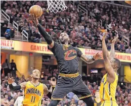  ?? TONY DEJAK/ASSOCIATED PRESS ?? LeBron James drives to the basket against Indiana’s Monta Ellis (11) and Rodney Stuckey (2) on Wednesday night in Cleveland. James had a team-high 31 points.