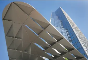  ?? Paul Chinn / The Chronicle ?? A canopy designed to baffle the wind rises above South Van Ness and Mission, where a 40story tower is nearing completion.