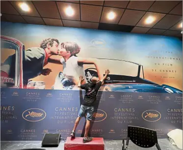  ??  ?? Final touch: A worker adjusting the official poster of the 71st Cannes Film Festival in the conference room of the Festival Palace in Cannes, France. — Reuters