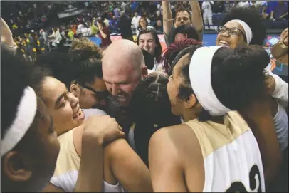  ?? The Sentinel-Record/Grace Brown ?? ONE SHINING MOMENT: Hot Springs coach Josh Smith celebrates with his team after the Lady Trojans’ 50-47 victory Saturday at Bank of the Ozarks Arena in the Class 5A state championsh­ip game against Watson Chapel.