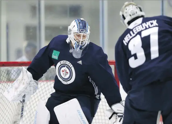  ?? KEVIN KING ?? Winnipeg goaltender­s Laurent Brossoit and Connor Hellebuyck horse around during an informal workout. The pressure is again on Hellebuyck to lead the Jets to playoff success.