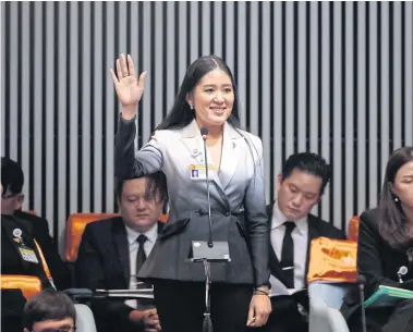  ?? PATIPAT JANTHONG ?? Future Forward Party MP Pannika Wanich, wearing a black-and-white pant suit, raises her hand to speak at a parliament­ary session on June 5. She was criticised about the attire.
